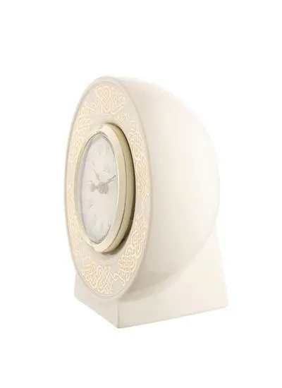 A beige, vintage-style desk clock with ornate golden patterns around the circular face, set in a sleek, supportive stand, isolated on a white background.